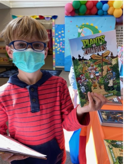 boy in mask holding book